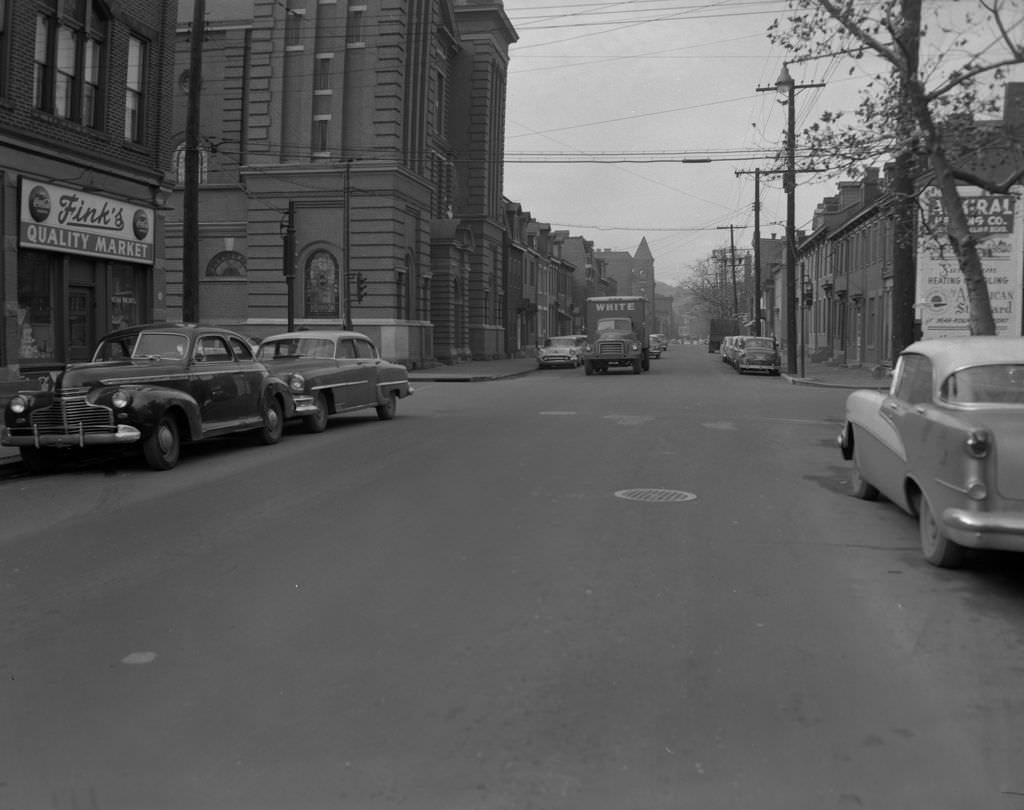 Sarah Street at the intersection with South 22nd Street featuring Fink's Quality Market and Saint Casimir Church, 1956