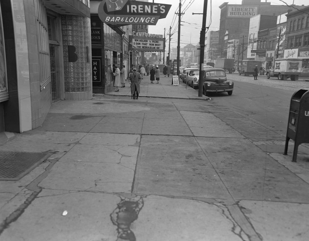 Penn Avenue in East Liberty showcasing the Liberty Building, Irene's Bar and Lounge, Cameraphone, and Isaly's, 1957