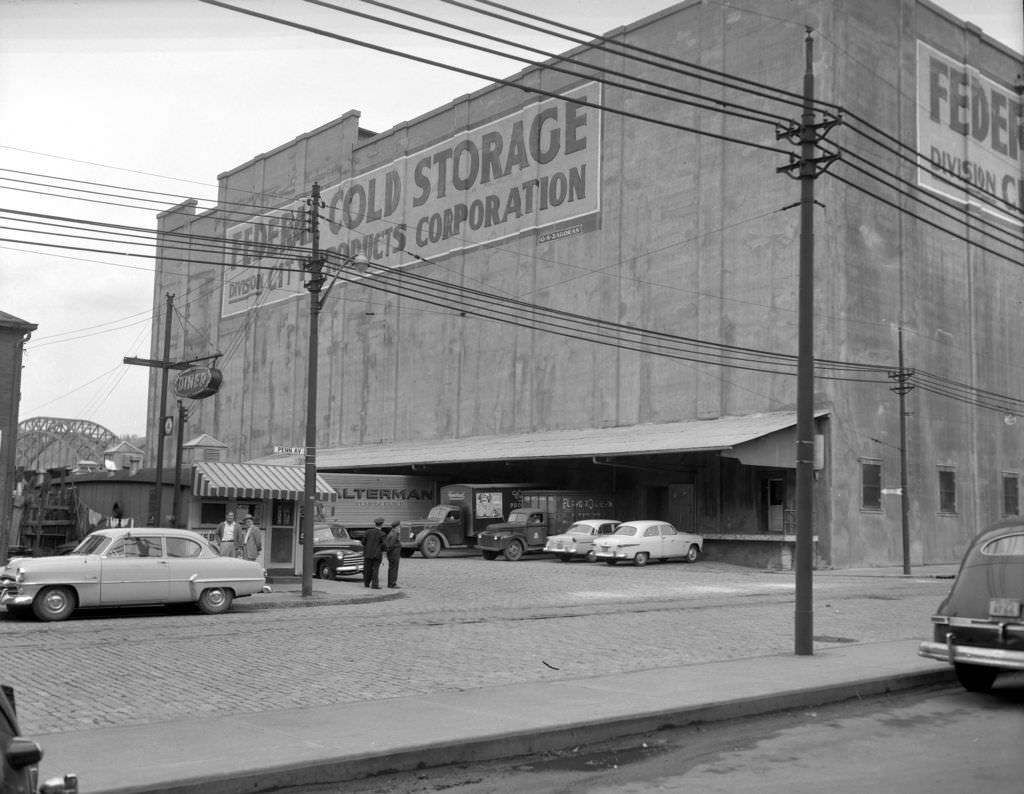 Federal Cold Storage building featuring a busy loading dock and diner, 1955