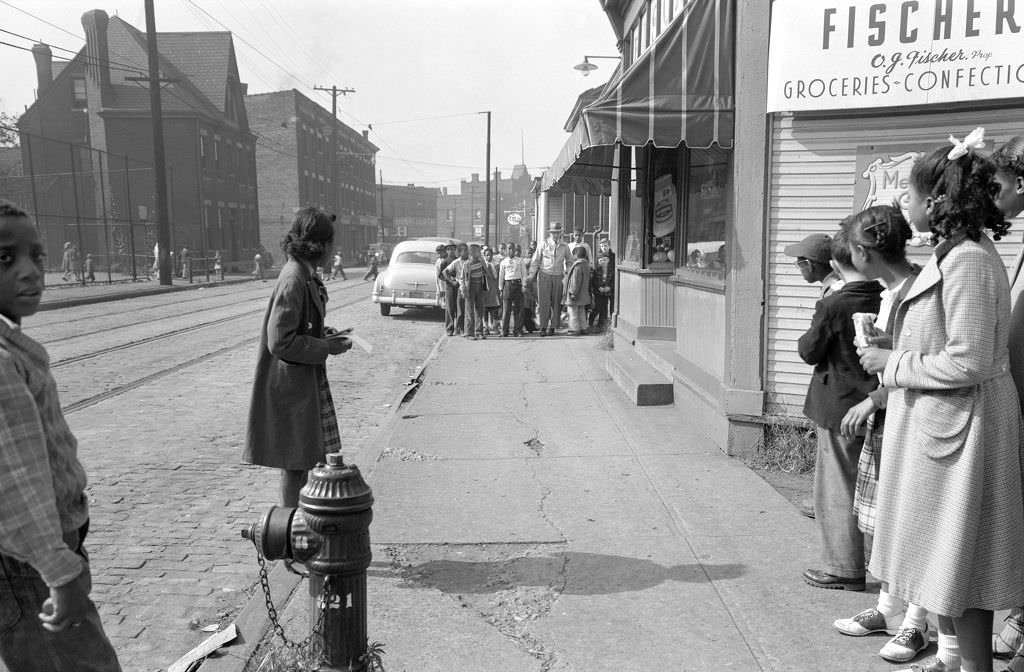 Group of children near Fischer Groceries look toward another group on Lincoln Avenue's 300 Block, 1950.