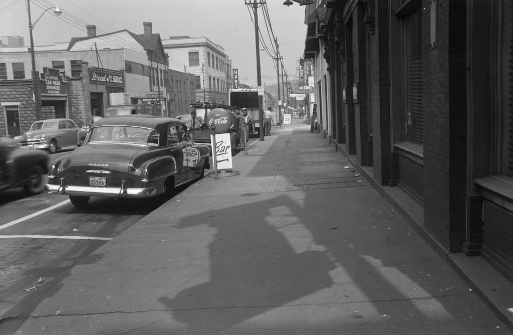 Broad and Collins Streets with St. Moritz Hotel and businesses, 1951.