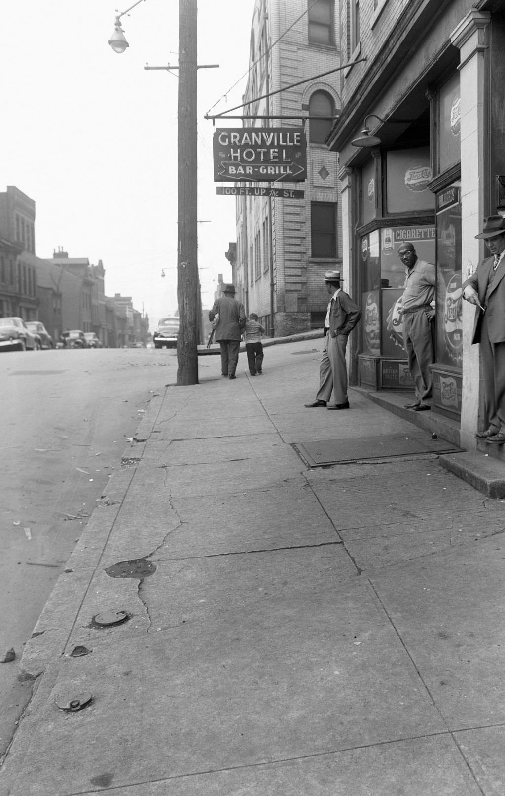 Man standing near Granville Hotel Bar and Grill on Wylie Avenue, 1954.