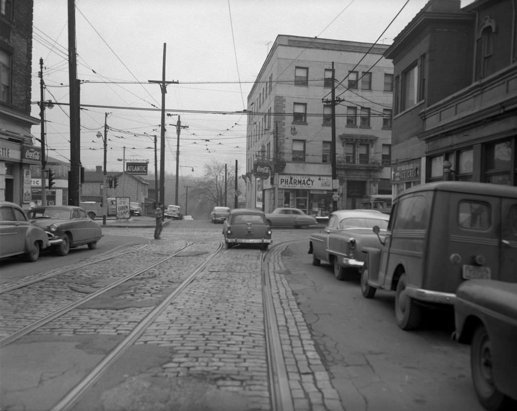 Cars and pedestrians at South Craig Street and Forbes Avenue intersection, 1956