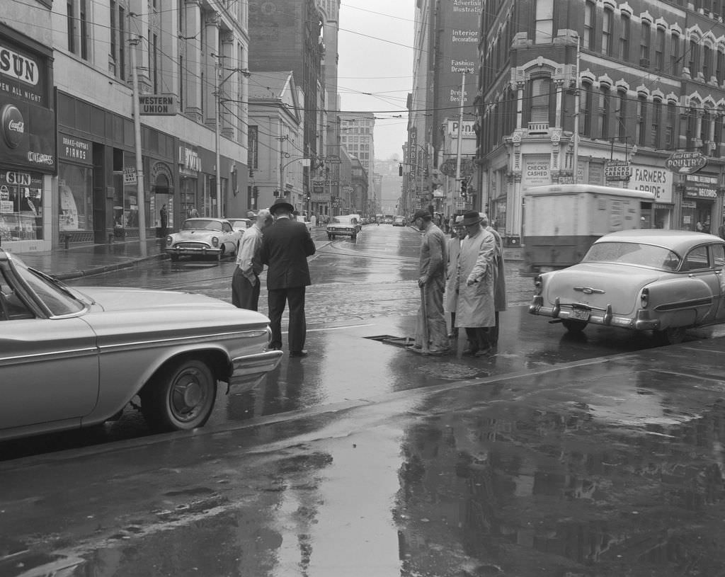 Liberty and Smithfield Streets, men near a manhole, Gimbel's Department Store visible, 1961.