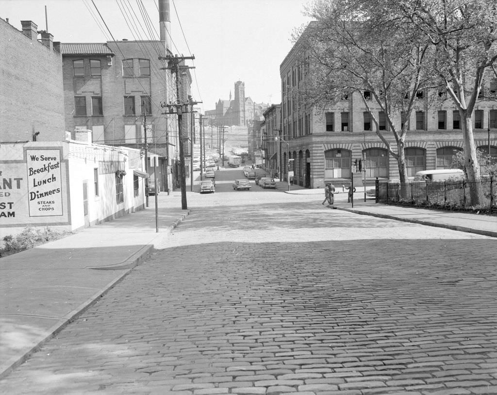 Forbes at Stevenson Street, hillside church framed by buildings, 1960.