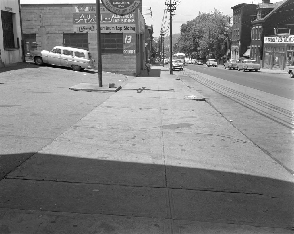 Penn Avenue, long view with trolley car and businesses including Triangle Electronics, 1960.