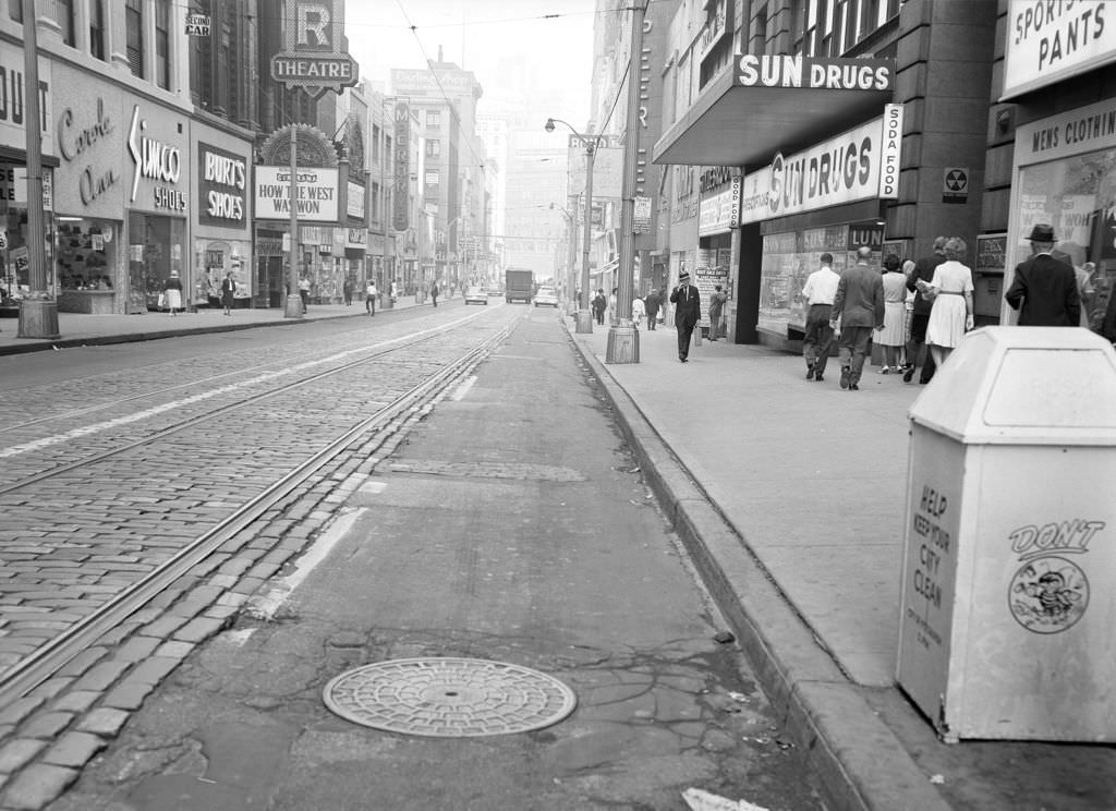 Fifth Avenue, features Burt's Shoes, McCrory's, and fallout shelter sign, 1963.