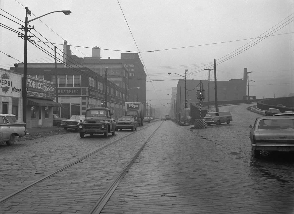 Liberty Avenue and 28th Street in the Strip District: brick streets and local businesses like Goodwill and Fiorucci Brother's Grill, 1966.