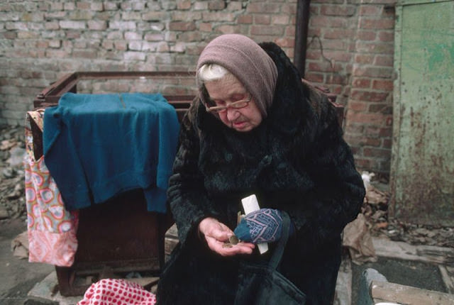 Elderly woman counting money, Ukraine, 1991