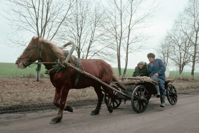 Farm couple riding on wagon, Ukraine, 1991