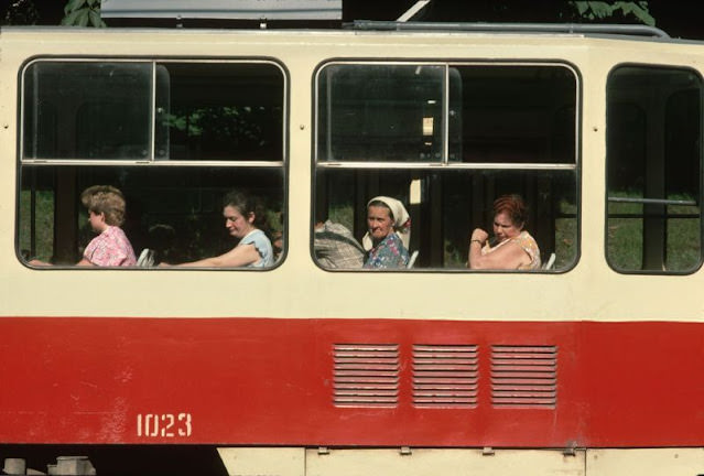 Passengers by windows of a train car, Ukraine, 1991