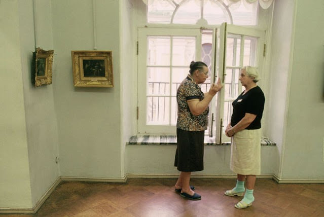 Two women chatting in the hallway of a building in Lviv, Ukraine, 1991