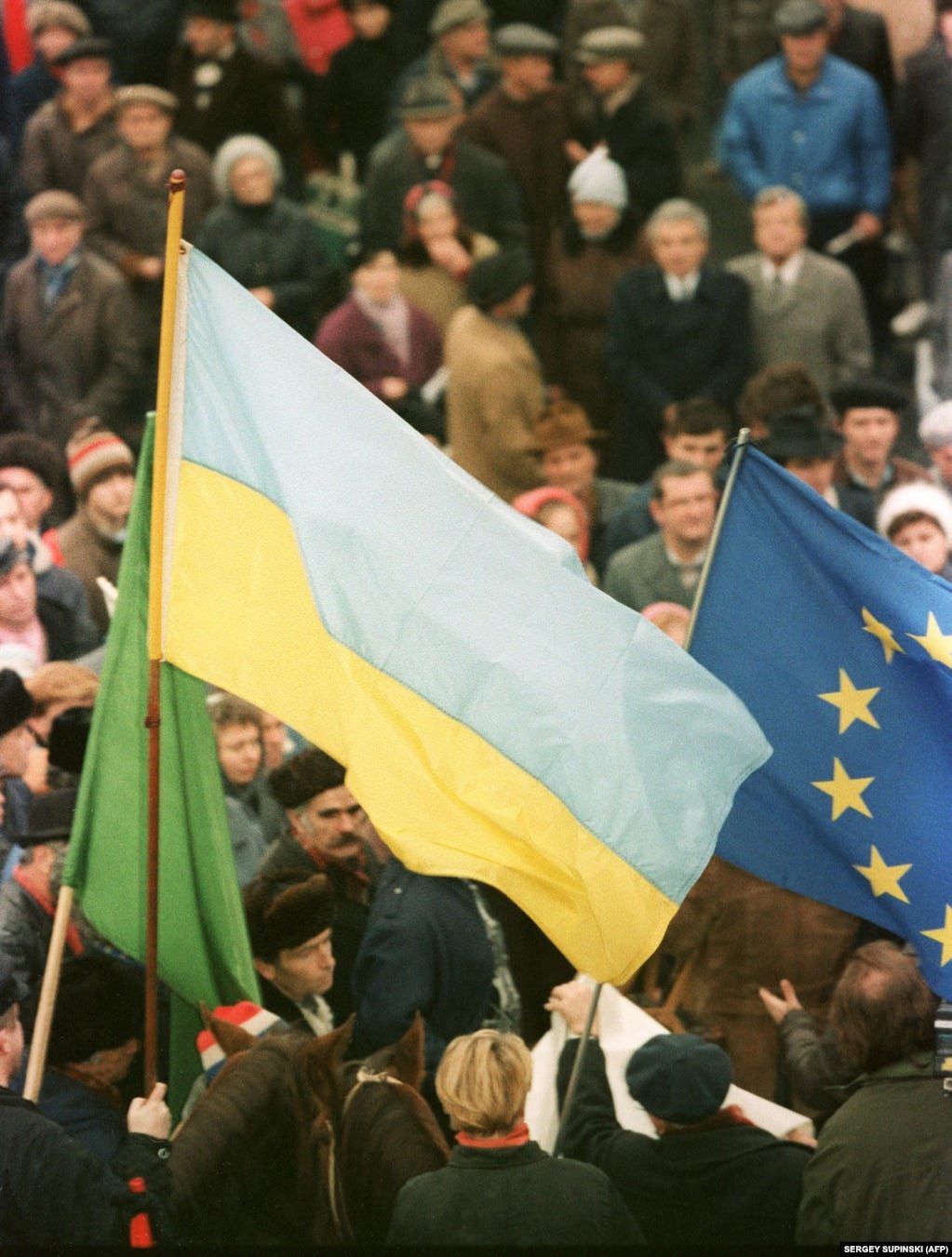 Both Ukrainian and European flags are seen during a pro-independence rally in Kyiv.