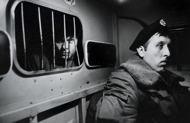An intoxicated person in the back of a police van, December 1992.