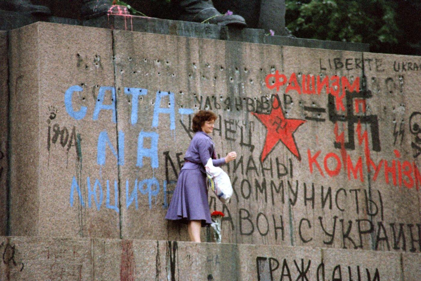 Woman Stands on Graffiti-Covered Lenin Monument Pedestal in Kiev, 1991