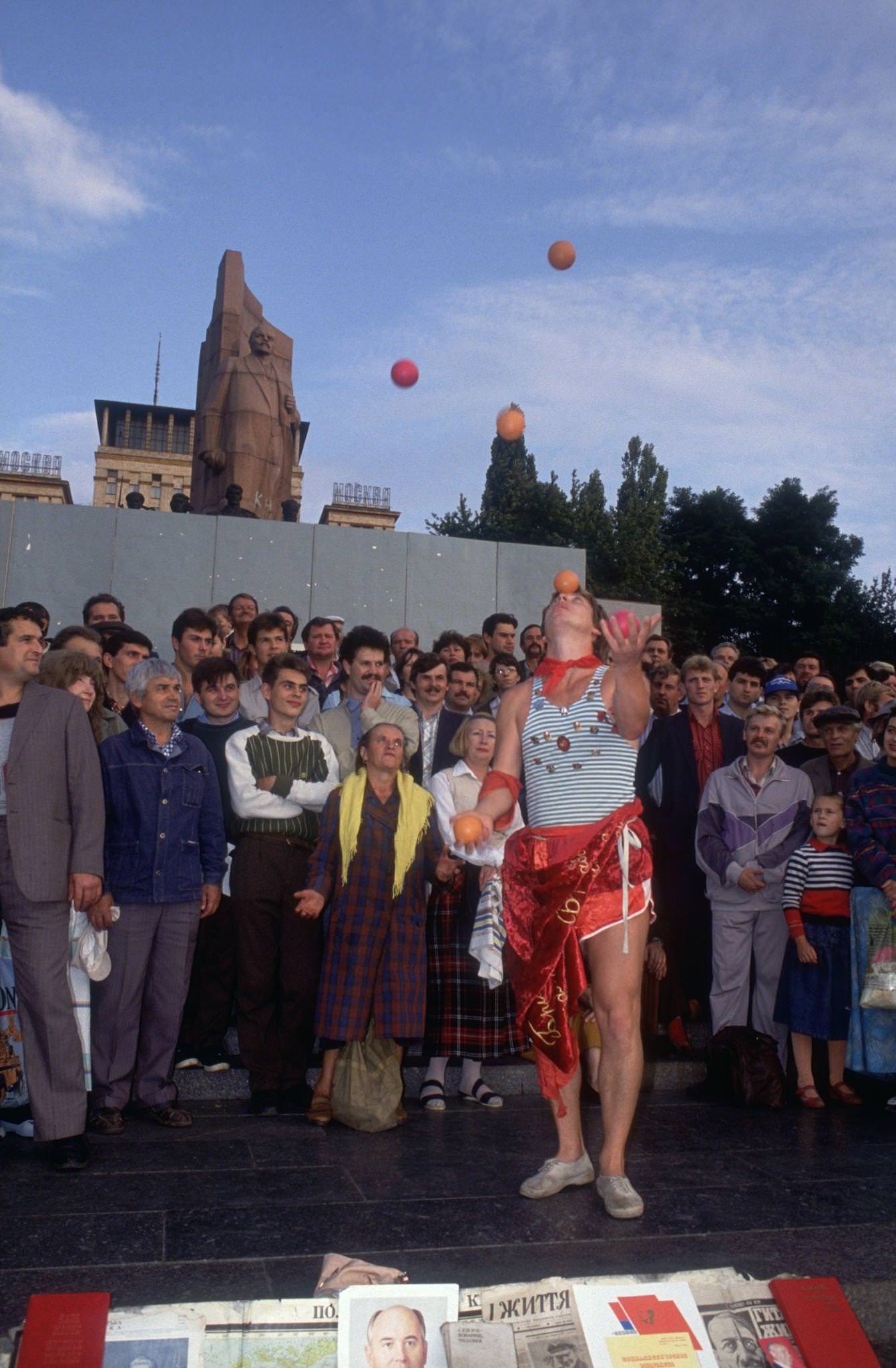 Juggler Entertains in Kiev with Lenin Statue in Background, 1991