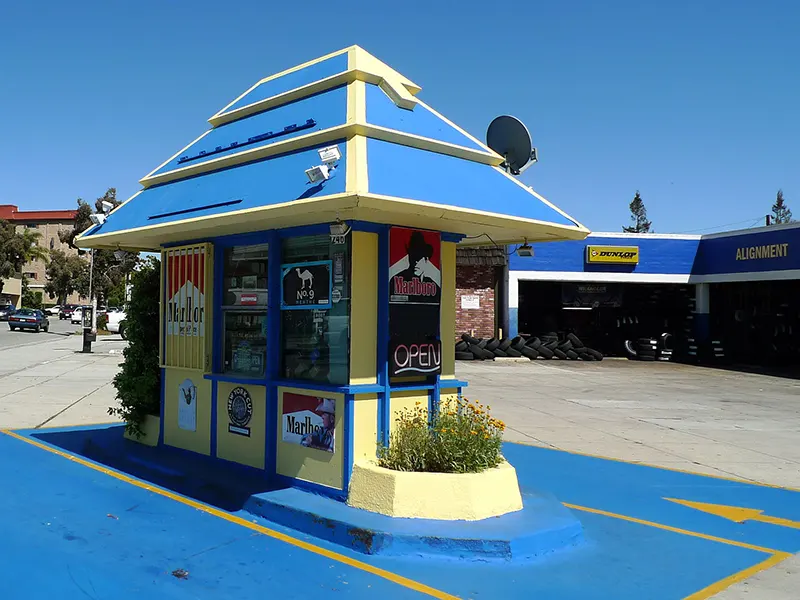 A former Fotomat kiosk, repainted and now selling cigarettes.