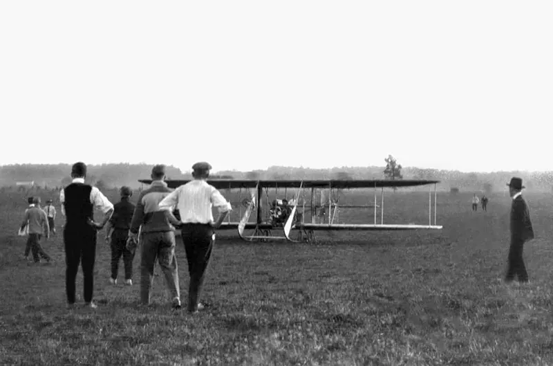 A crowd gathers to see an early aircraft in Ohio, 1900s.