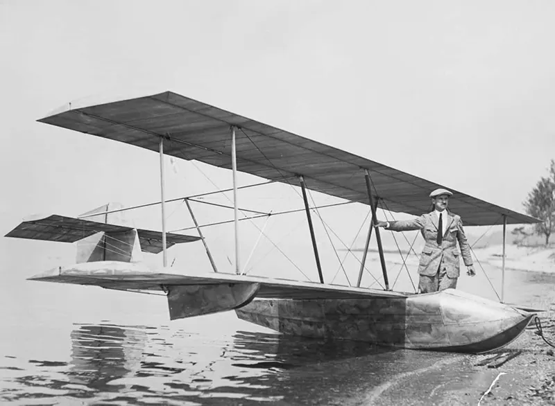 Pioneering Aviator Glenn Curtiss standing by one of his early gliders.