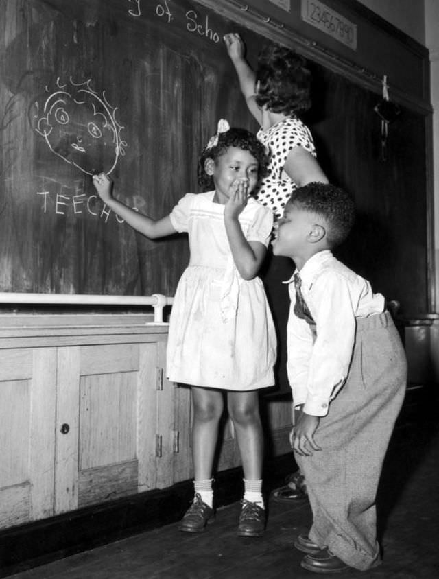 Joyce Payne and Vincent Baker have fun depicting their teacher at a school in New York’s Harlem community on Sep. 13, 1948