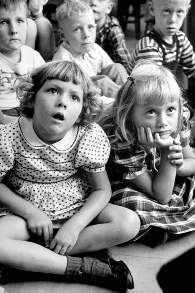 Wide-eyed children listening to fairy-tales on their first school day in 1949