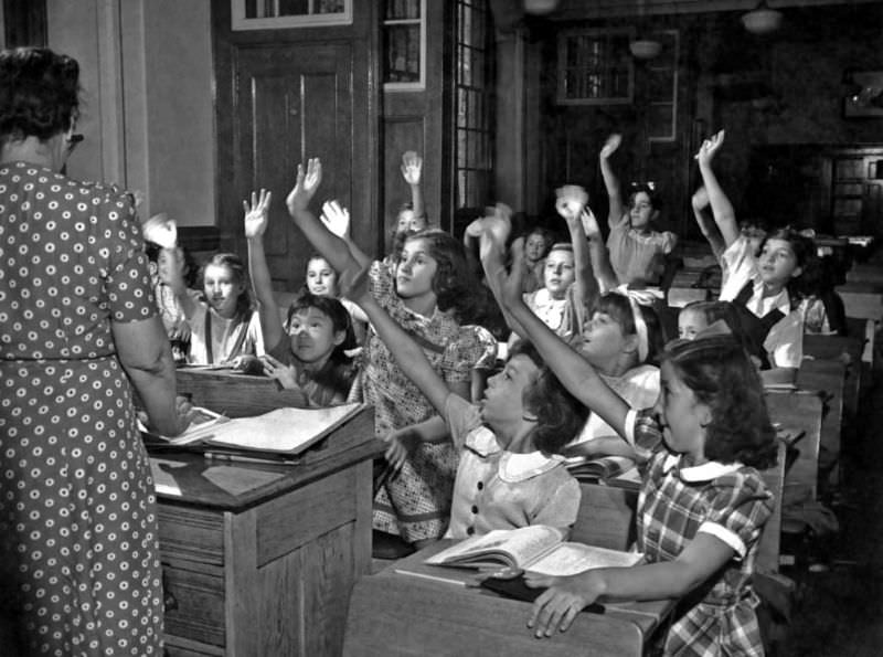 Students eagerly vie to be called on at a New York school, circa 1950