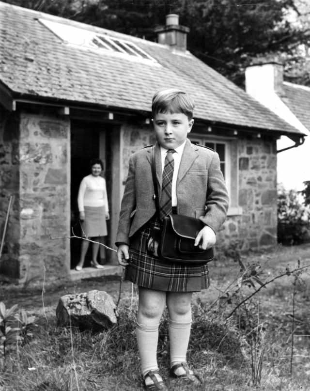 Teacher Agnes Bolton stands in the schoolhouse door on the first day of classes for her only pupil, Jimmy MacLellan, in Scotland, circa 1950