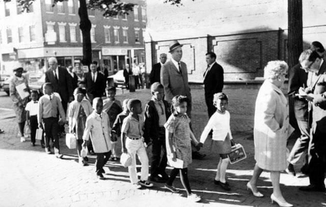 Mary Lynch, an assistant principal at a school in Boston’s Roxbury community, leads first graders to a school in the city’s North End on Sept. 6, 1967. Operation Exodus, a voluntary busing program organized by Roxbury parents, transported students from overcrowded schools in predominantly black neighborhoods to schools in predominantly white neighborhoods that had vacant seats