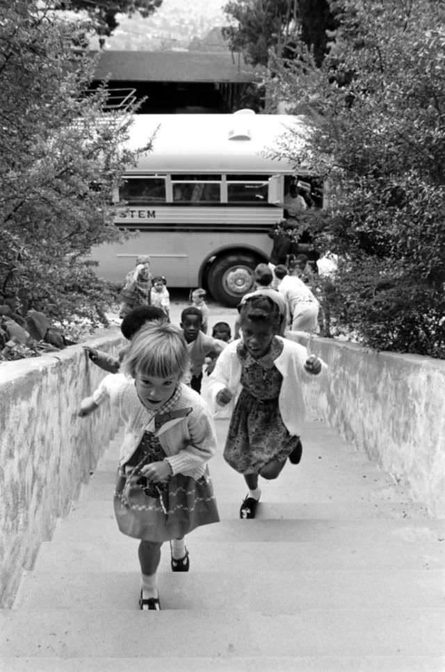 Children walk up a flight of stairs to attend a newly desegregated school in Berkeley, California, 1968