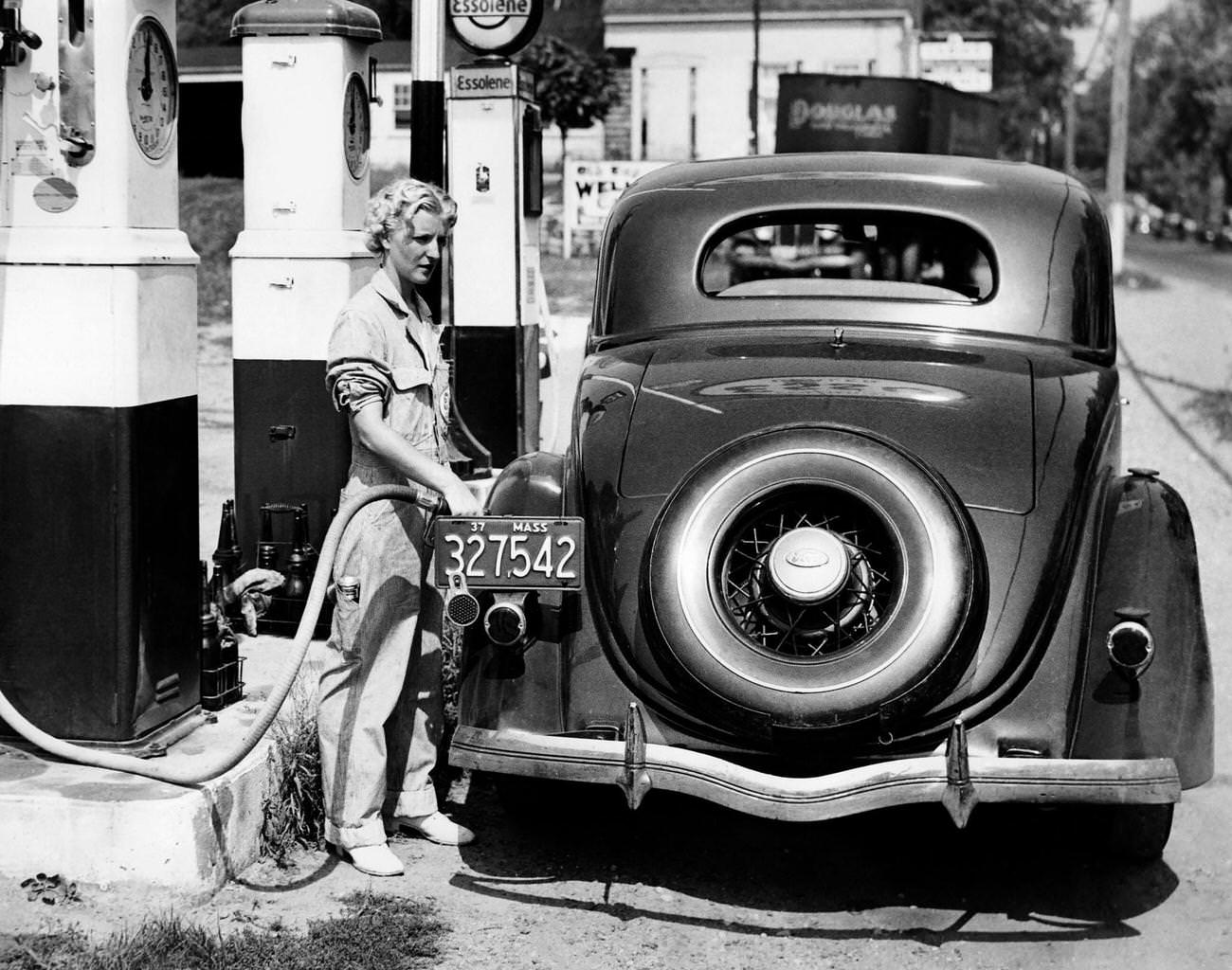 Fuel pump employee fills a car in Danvers, Massachusetts, 1937.
