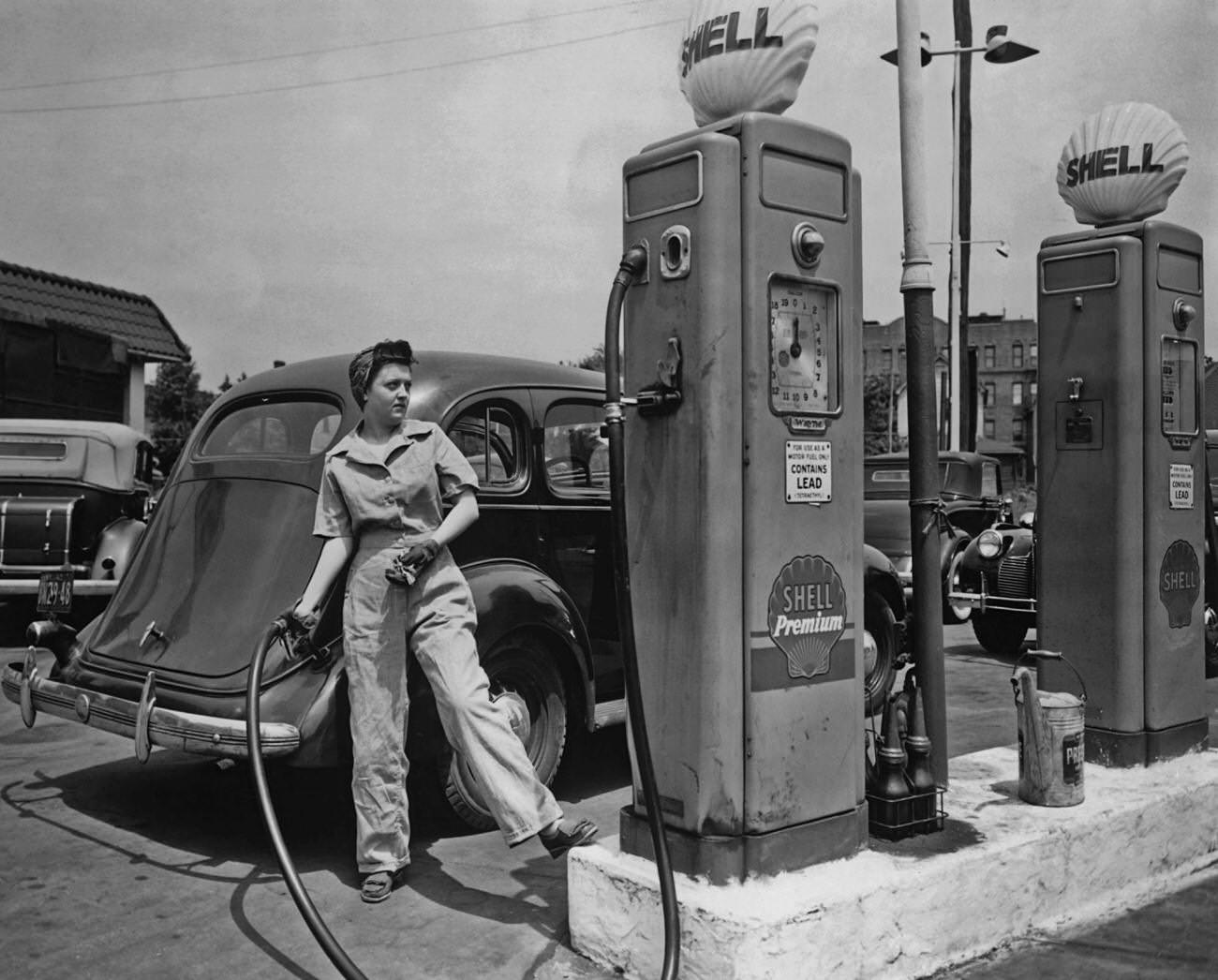 Woman pumping gas at Shell station in New York during World War 2.