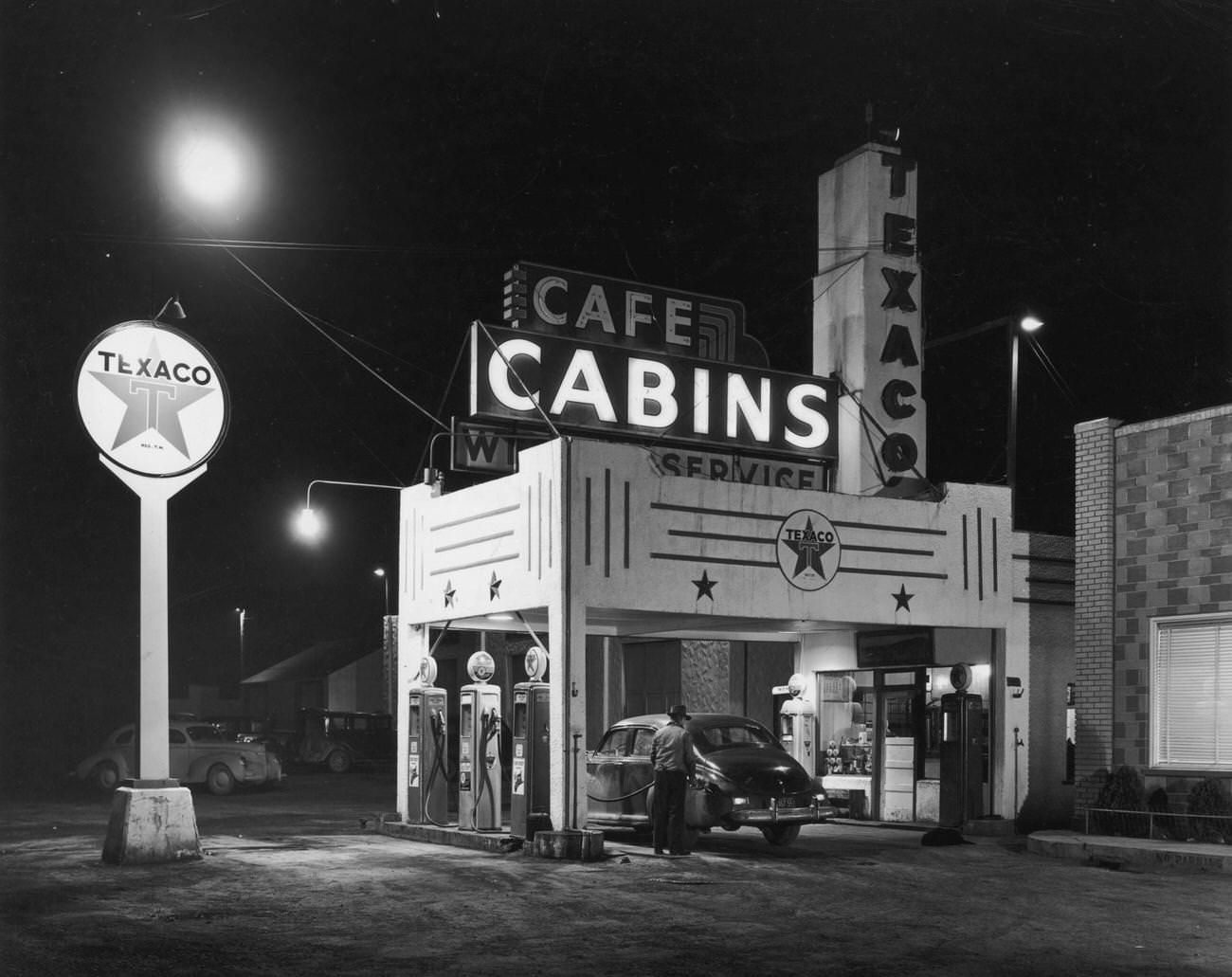 Man fills gas tank at Texaco station and rest stop in Wendover, Utah.