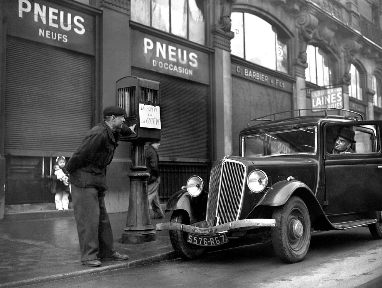 Petrol pump attendant during gas stations strike in Paris, 1947.