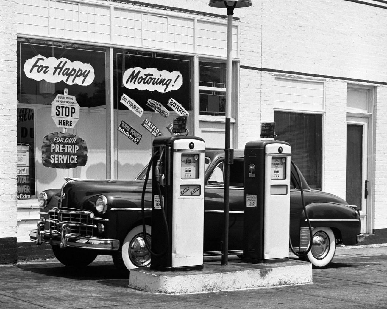 Dodge car in a service station, 1950s.