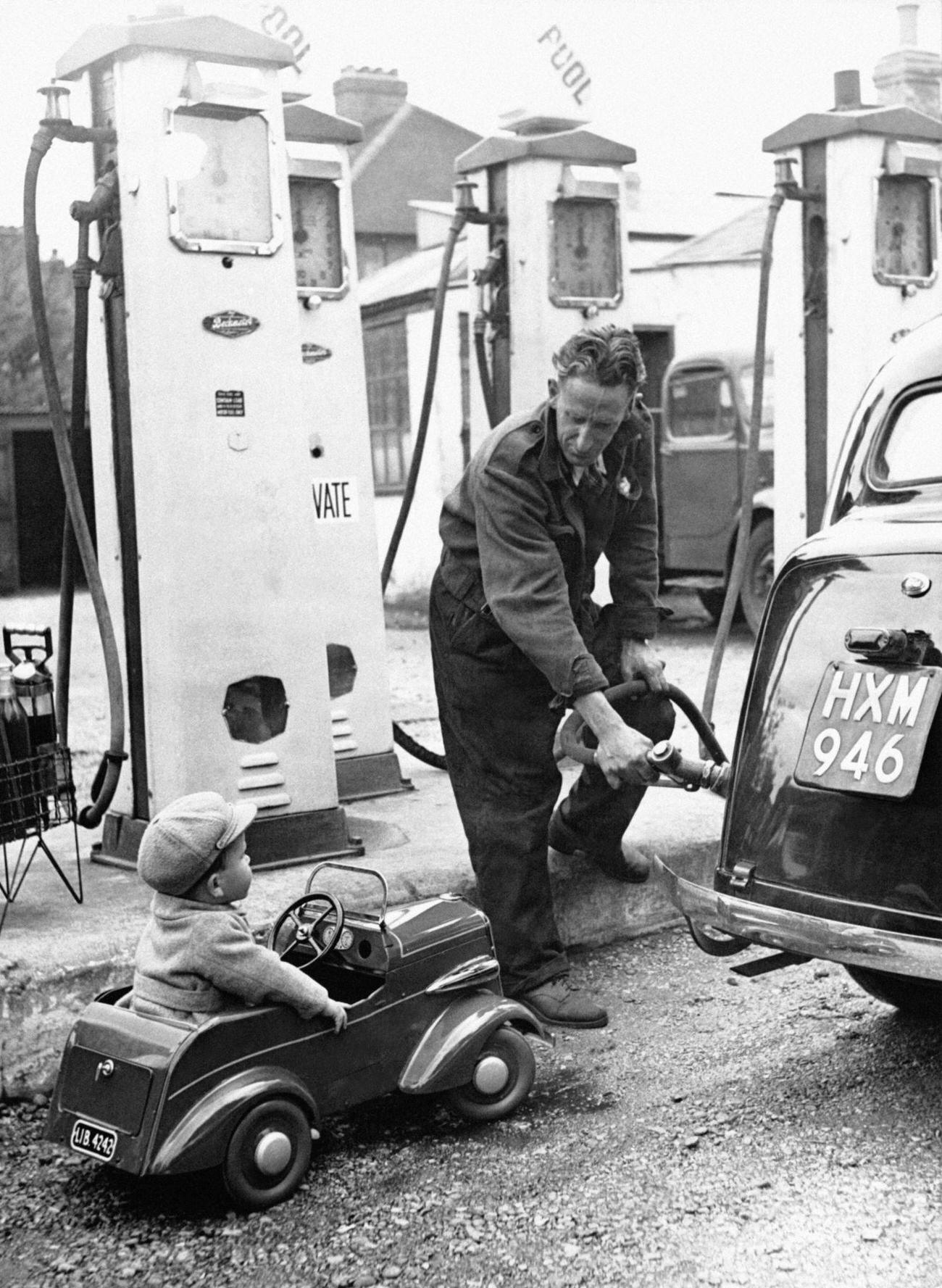 Young Boy in Mini-Car Queuing at a UK Gas Station