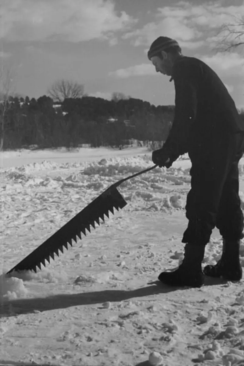 A photograph that captures the ice cutting process on the Ottauquechee River in 1936.