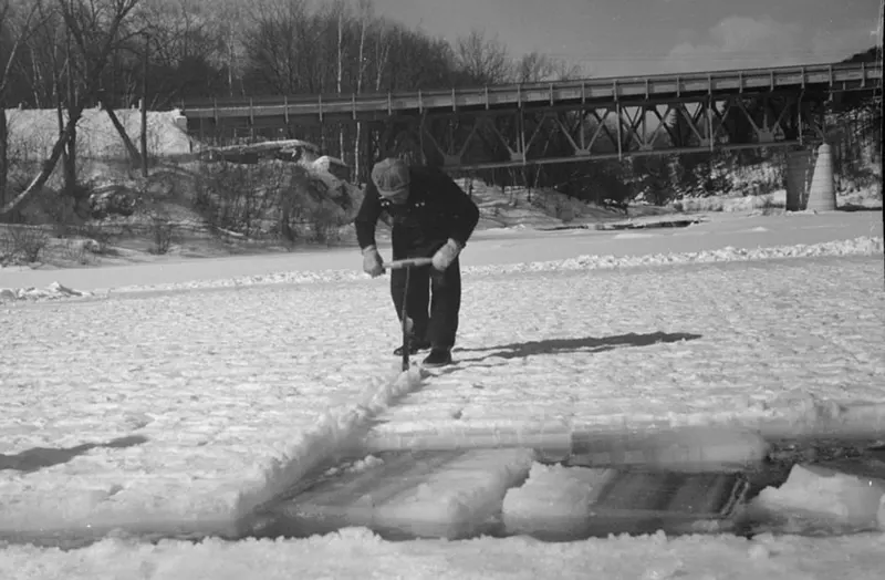 A photograph that captures the ice cutting process on the Ottauquechee River in 1936.