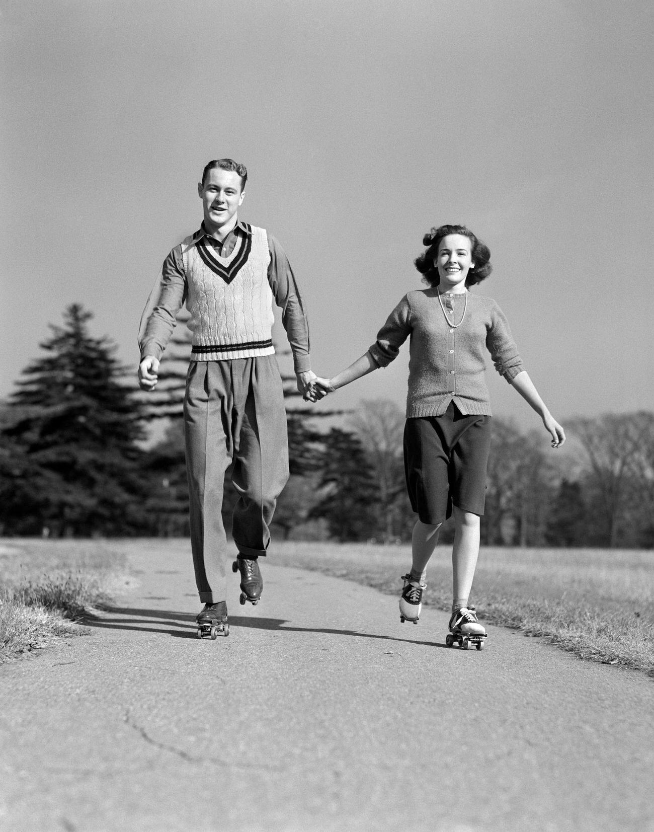 Smiling Teenage Couple Roller Skating, 1940s.