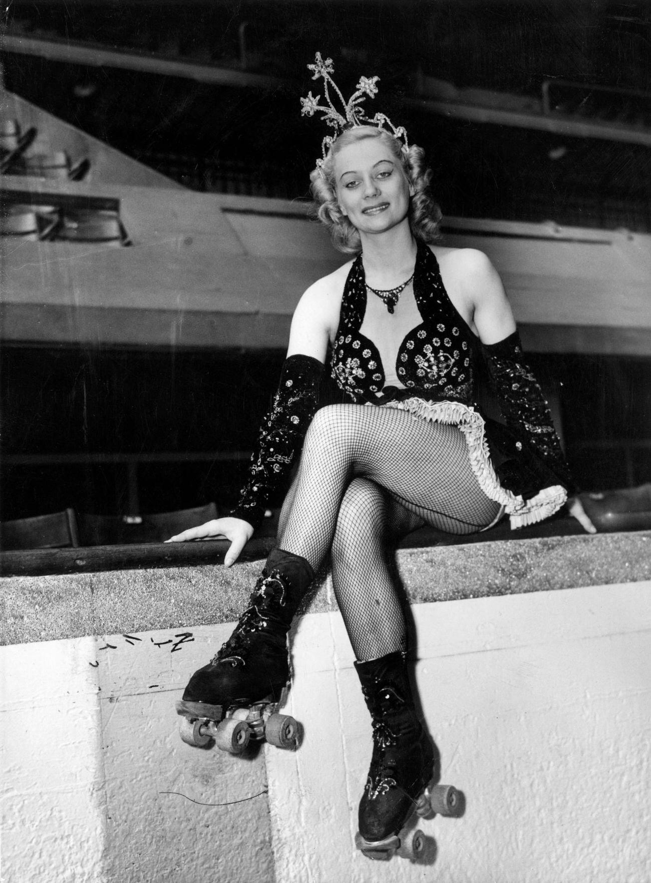 Roller Skater Sitting at the Edge of the Rink, circa 1950.