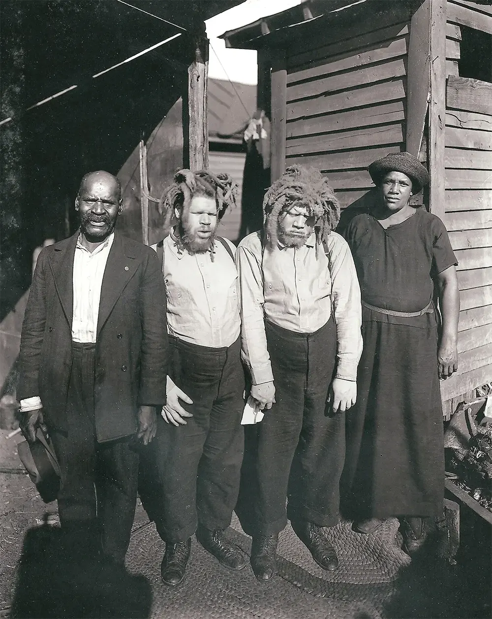 Harriett Muse, right, and husband Cabell, far left, with the brothers shortly after she found them at a sideshow in 1927.
