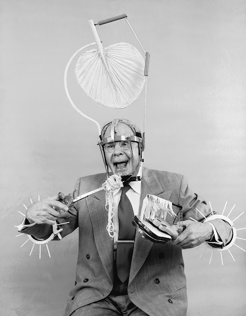 Russell E. Oakes Wearing His Problem-Solving Inventions, Including Spikes and a Wind-Up Spaghetti Eater, 1955