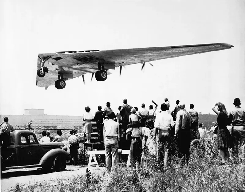 A crowd watches as the XB-35 takes off on its maiden flight.