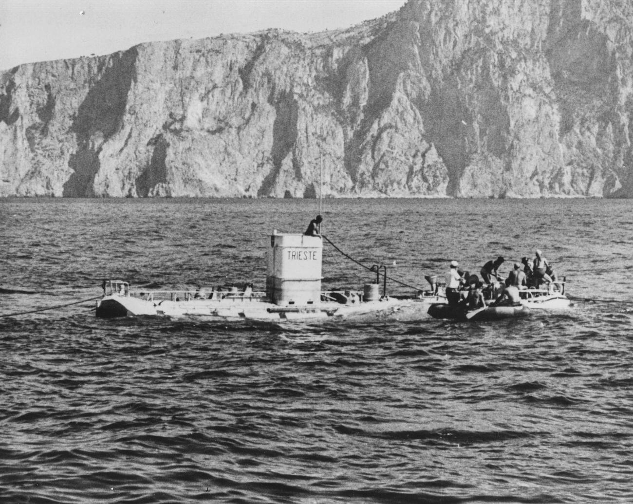 Auguste and Jacques Piccard boarding a rowing boat after surfacing in 'Trieste', 1953.