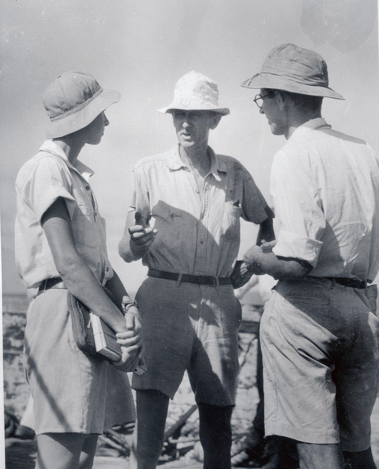 Dr. William Beebe discussing ocean exploration with aides Gloria Hollister and John Tee-Van.