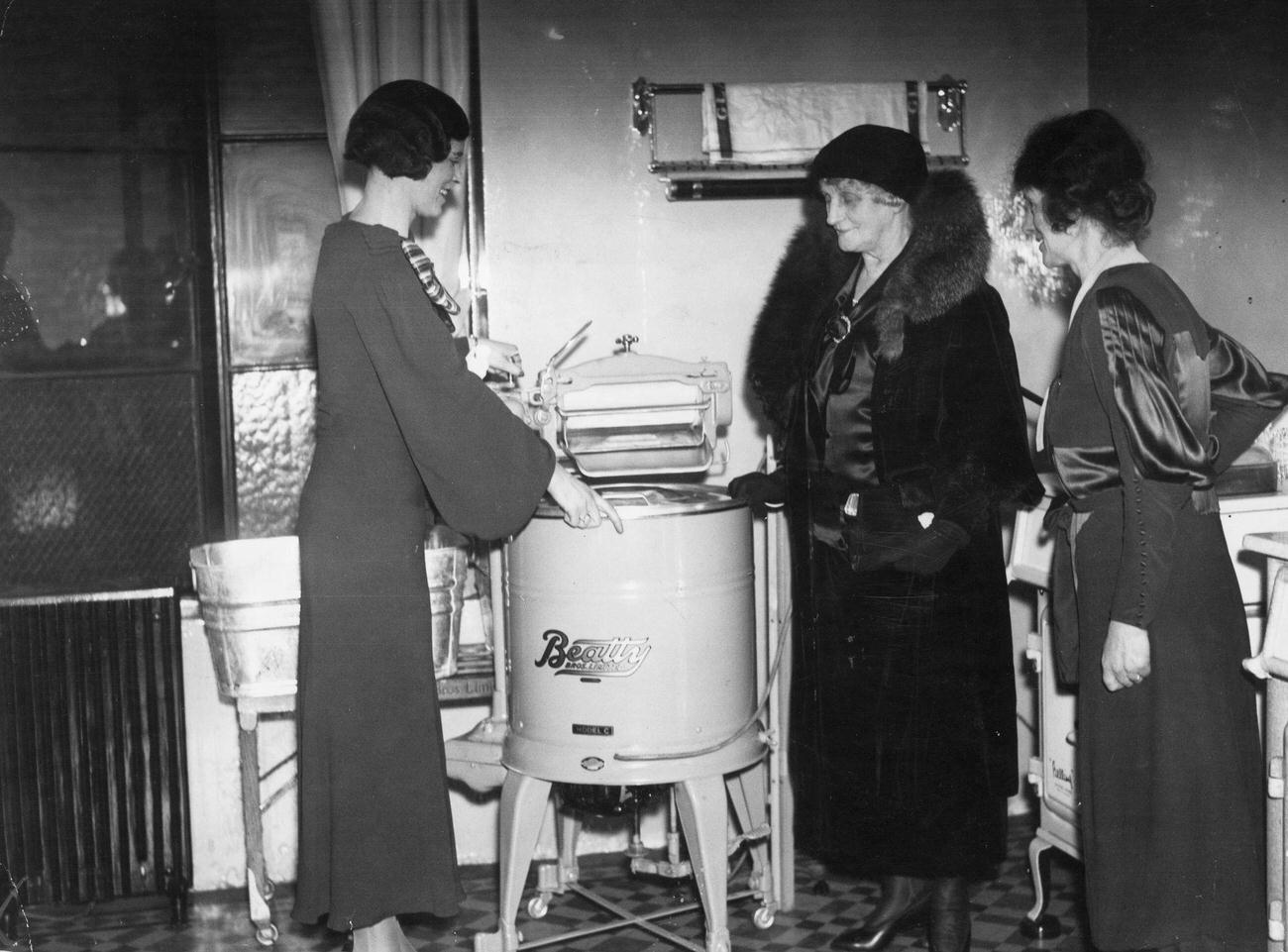 Lady Moir inspecting an electrical washing machine, 1934.