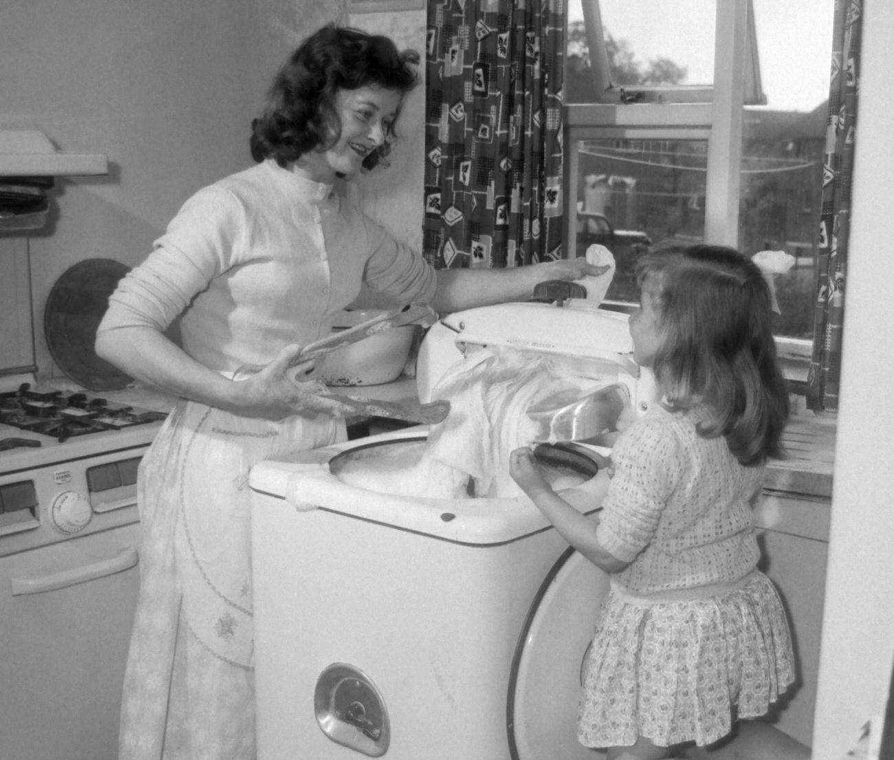 Mother and daughter with new washing machine, 1958.