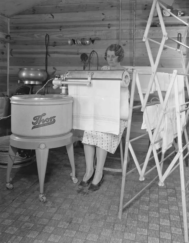 Farm woman using electric mangle, Montgomery County, Indiana, 1930.