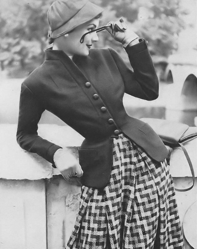 Model in Madeleine de Rauch's gray flannel and tweed outfit, Vogue, September 1, 1952.
