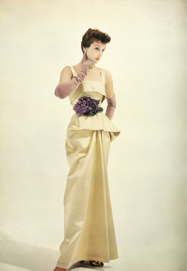 Model in Frederick Starke's gold satin evening dress and Cartier jewelry, Harper's Bazaar UK, October 1950.
