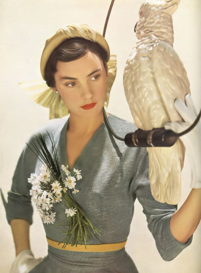 Model in R.M.Hats' lime straw hat and Matita's gray wool dress, Harper's Bazaar UK, February 1950.